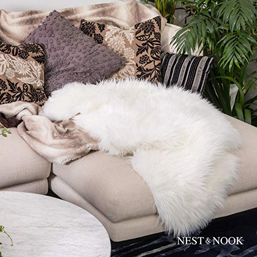 Nest and Nook White Faux Fur Rug/Throw/Blanket Nest and Nook White Fake Fur Rug/Throw/Blanket, Fake Fur Sheepskin, Off White - Furry Delicate Throw with Non-Slip Suede-Like Backing, Animal Cruelty Free. Space Carpet or Cowl for Stool, Chair, Mattress.