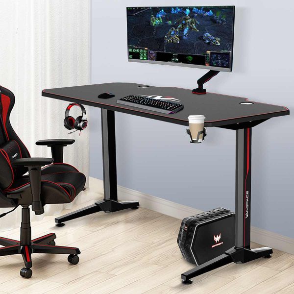 Professional Gaming Desk: Ergonomic PC Computer Workstation Furniture The luxurious black color and modern design of this gaming desk add a touch of sophistication to your gaming space. It's not only functional but also aesthetically pleasing, enhancing the overall look of your gaming setup. Durable Construction: The desk is constructed with high-quality particleboard and metal materials, ensuring long-lasting durability and stability. It can withstand the rigors of gaming, including heavy equipment and intense gameplay. Spacious Desktop: With a desktop size of 55.1" L x 23.6" W, you'll have ample space to accommodate multiple monitors, gaming peripherals, and other accessories. The generous surface area provides a clutter-free gaming experience. The 55 Inch Gaming Desk comes with a free mouse pad and is designed as an ergonomic T-shaped office desk. This piece of furniture is perfect for PC and computer gaming, serving as a professional workstation for gamers.